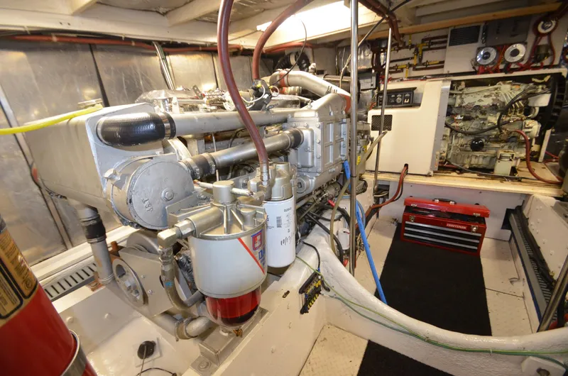 Slide: The Image of Engine room of 1989 Silverton Aft Cabin 46 yacht, showcasing mechanical components and equipment. - 52