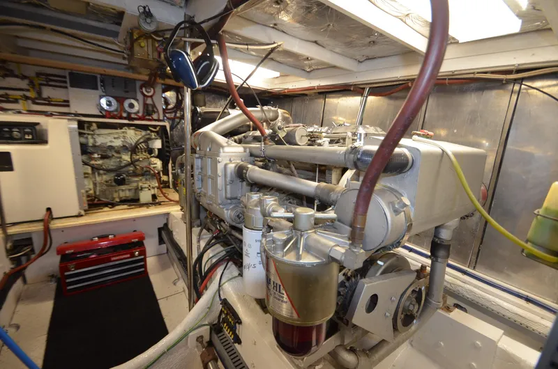 Slide: The Image of Engine room of 1989 Silverton Aft Cabin 46 yacht, showcasing mechanical components and equipment. - 53