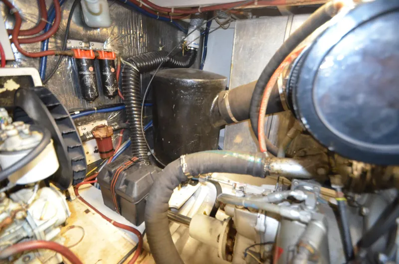 Slide: The Image of Engine room of 1989 Silverton Aft Cabin 46 with visible components and wiring. - 55