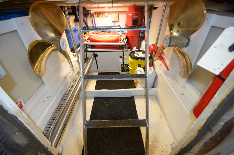 Slide: The Image of Engine room of 1989 Silverton Aft Cabin 46 with propellers and equipment. - 59