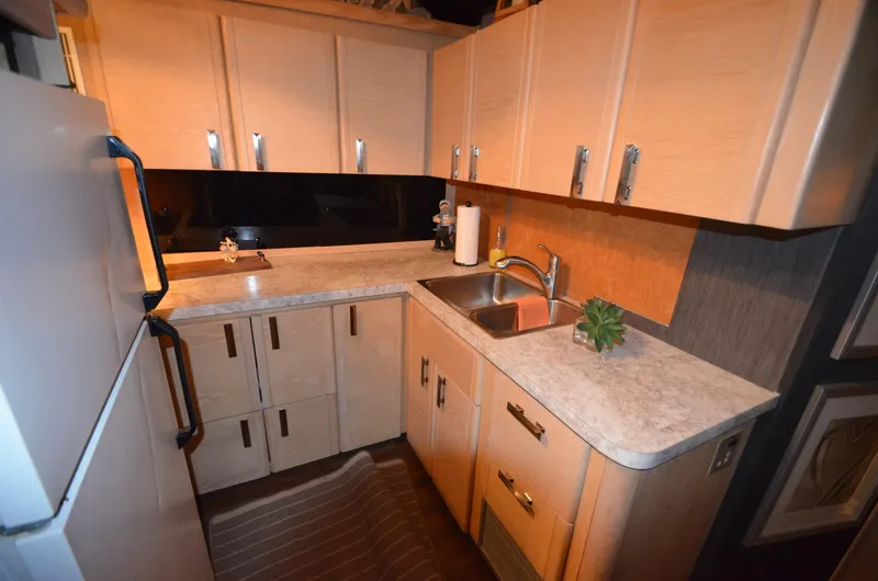 Slide: The Image of 1989 Silverton Aft Cabin 46 yacht kitchen with modern cabinetry and countertops. - 6