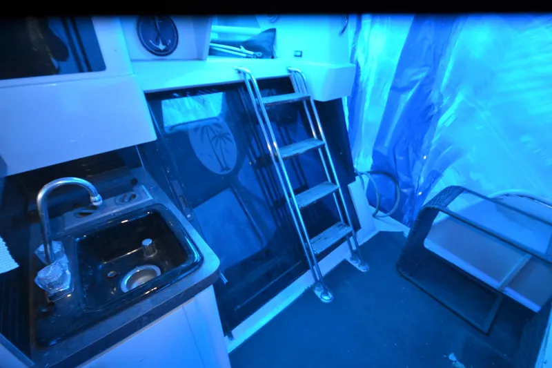 Slide: The Image of 1989 Silverton 46 Aft Cabin interior with sink, stairs, and blue lighting. - 69