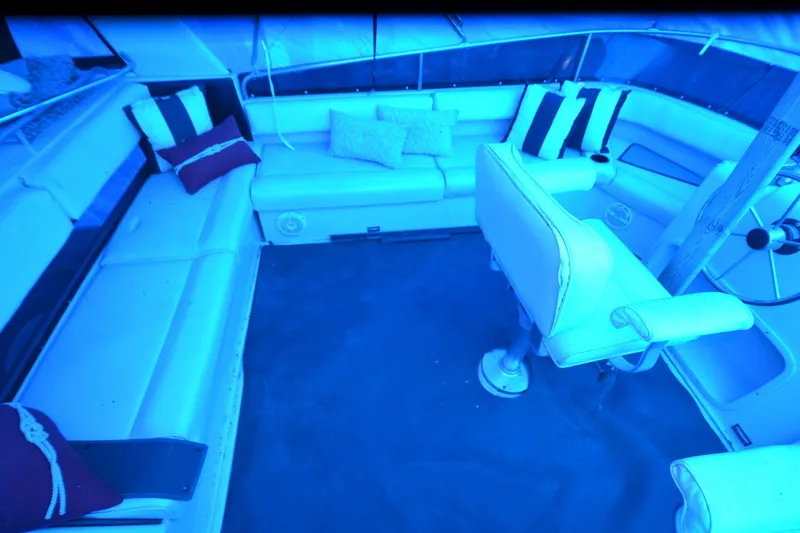 Slide: The Image of 1989 Silverton 46 Aft Cabin interior with white seating and nautical-themed cushions. - 72