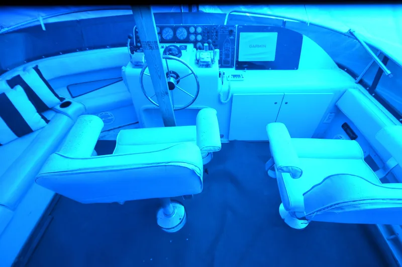 Slide: The Image of Interior cockpit of 1989 Silverton 46 Aft Cabin yacht with steering wheel and seating. - 75