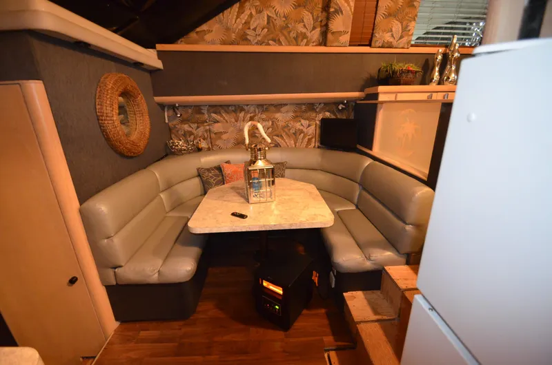 Slide: The Image of 1989 Silverton Aft Cabin 46 interior with cozy seating and decorative elements. - 8