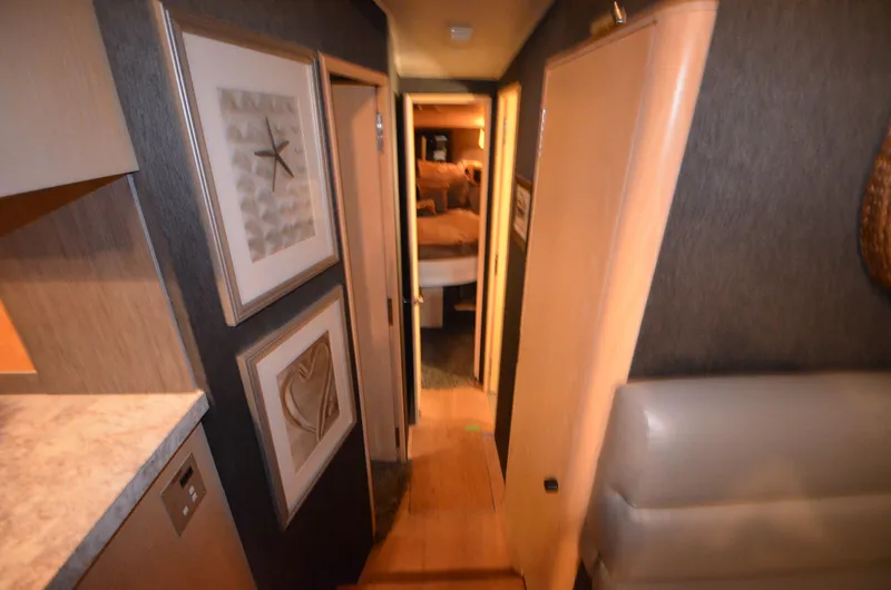 Slide: The Image of Interior hallway of 1989 Silverton Aft Cabin 46 yacht, featuring framed artwork and cozy decor. - 9