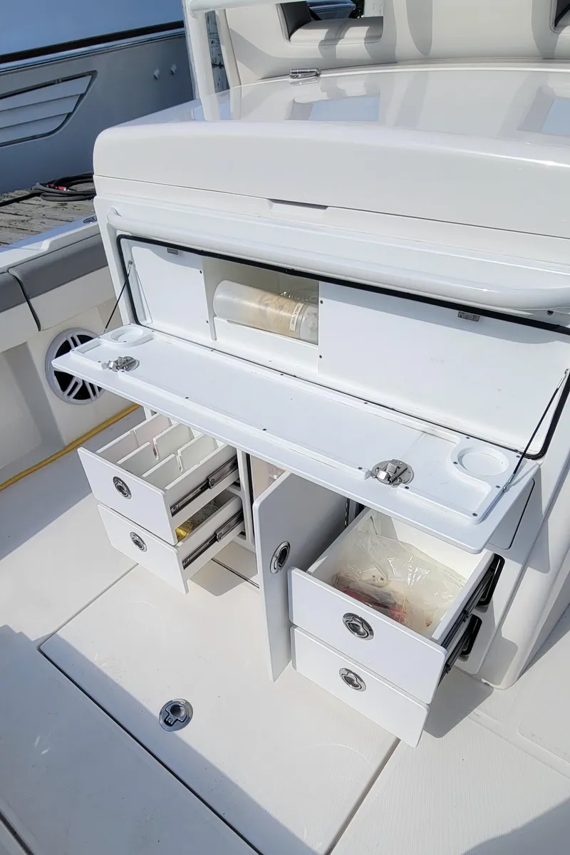 Slide: The Image of 2023 Regulator 34 boat interior with open storage compartments and drawers. - 15