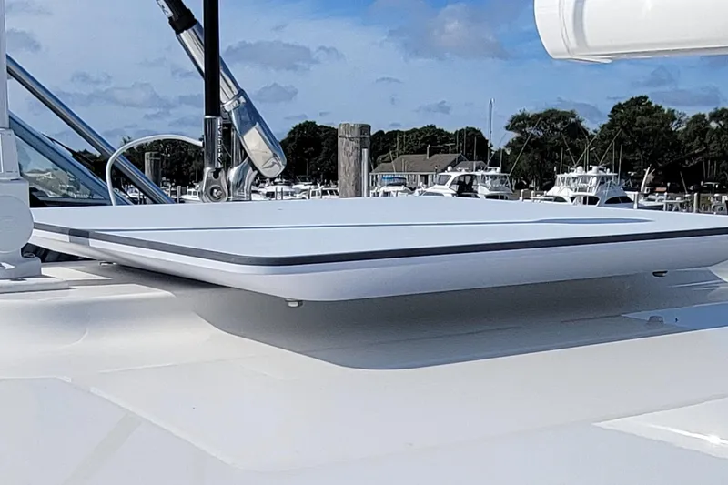 Slide: The Image of 2023 Regulator 34 boat rooftop detail with clear sky and marina background. - 18