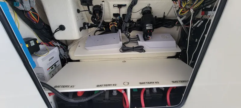 Slide: The Image of 2023 Regulator 34 boat battery compartment with wiring and equipment. - 20