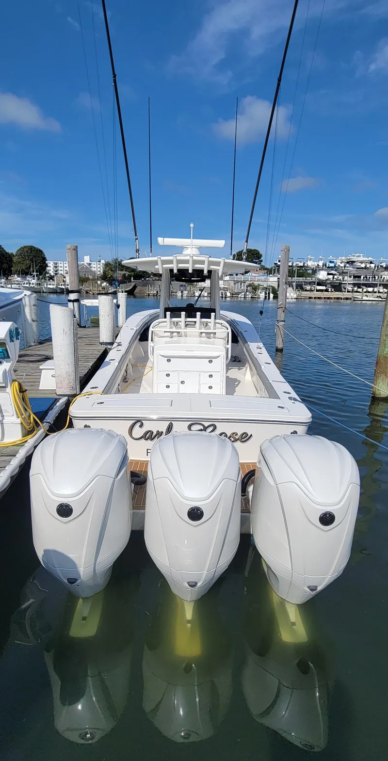 Slide: The Image of 2023 Regulator 34 boat with triple engines docked in a marina. - 3