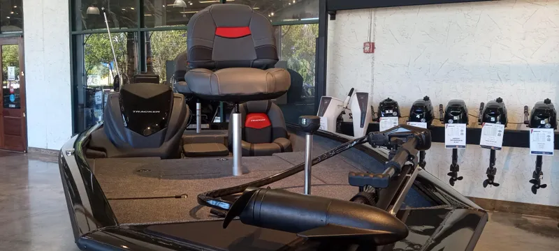 Slide: The Image of 2025 Tracker Pro Team 175 boat displayed in showroom with seating and equipment. - 3