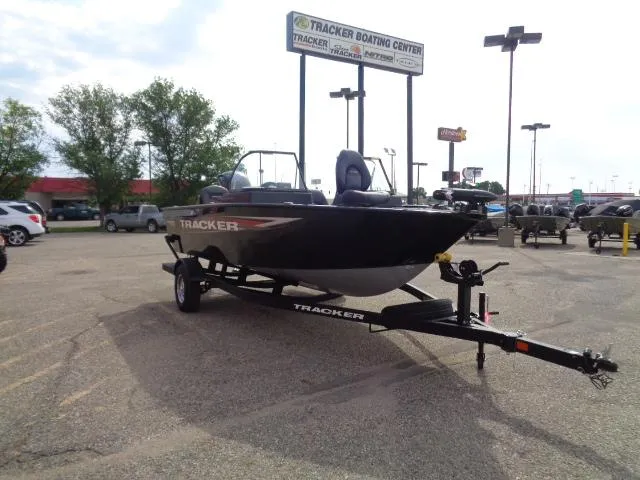 Slide: The Image of 2025 Tracker Pro Guide V-175 Combo boat on trailer at dealership parking lot. - 3