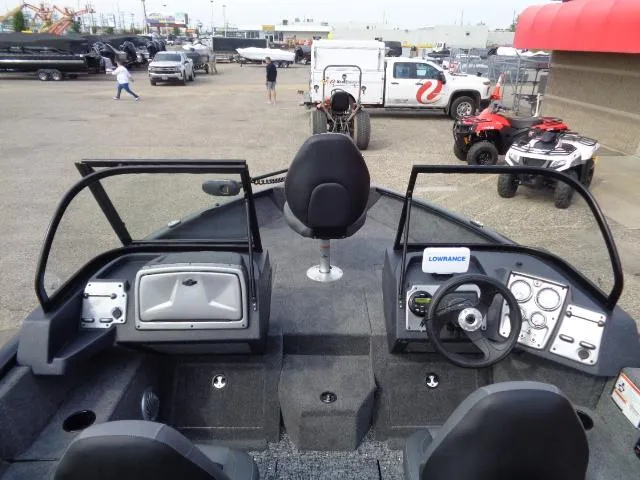 Slide: The Image of 2025 Tracker Pro Guide V-175 Combo boat interior with steering wheel and dashboard controls. - 6