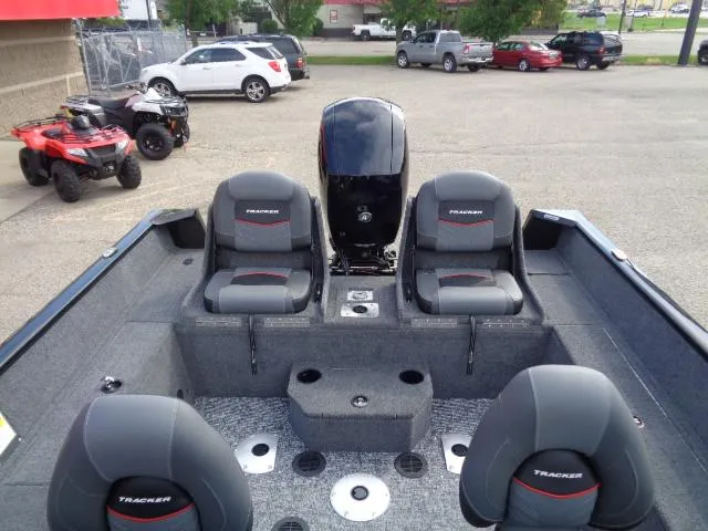 Slide: The Image of 2025 Tracker Pro Guide V-175 Combo boat interior with seating and motor. - 7