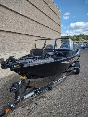Slide: The Image of 2025 Tracker Pro Guide V-16 WT boat on trailer, parked outdoors. - 5