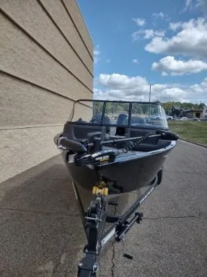 Slide: The Image of 2025 Tracker Pro Guide V-16 WT boat on trailer, parked outdoors. - 6