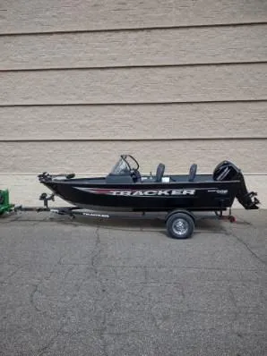 Slide: The Image of 2025 Tracker Pro Guide V-16 WT fishing boat on trailer, parked outdoors. - 7