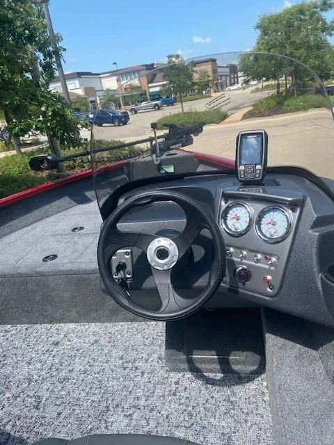 Slide: The Image of 2025 Tracker Pro Guide V-16 SC boat dashboard with steering wheel and gauges. - 3