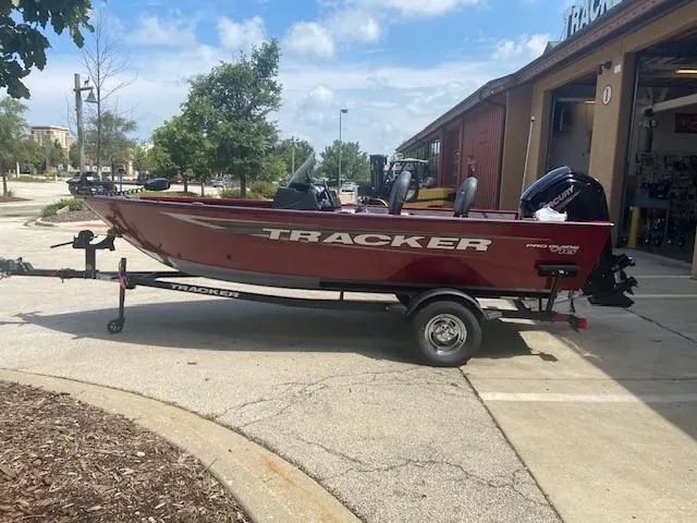 Slide: The Image of 2025 Tracker Pro Guide V-16 SC boat on trailer, parked outdoors. - 4