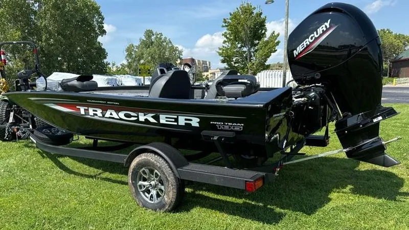Slide: The Image of 2025 Tracker Pro Team 195 Tournament Edition boat with Mercury engine on grass. - 3