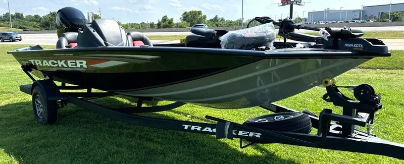 Slide: The Image of 2025 Tracker Pro Team 195 Tournament Edition boat on trailer, parked on grass. - 4