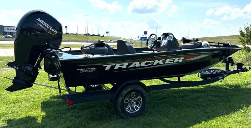 Slide: The Image of 2025 Tracker Pro Team 195 Tournament Edition boat on trailer, grassy background. - 5