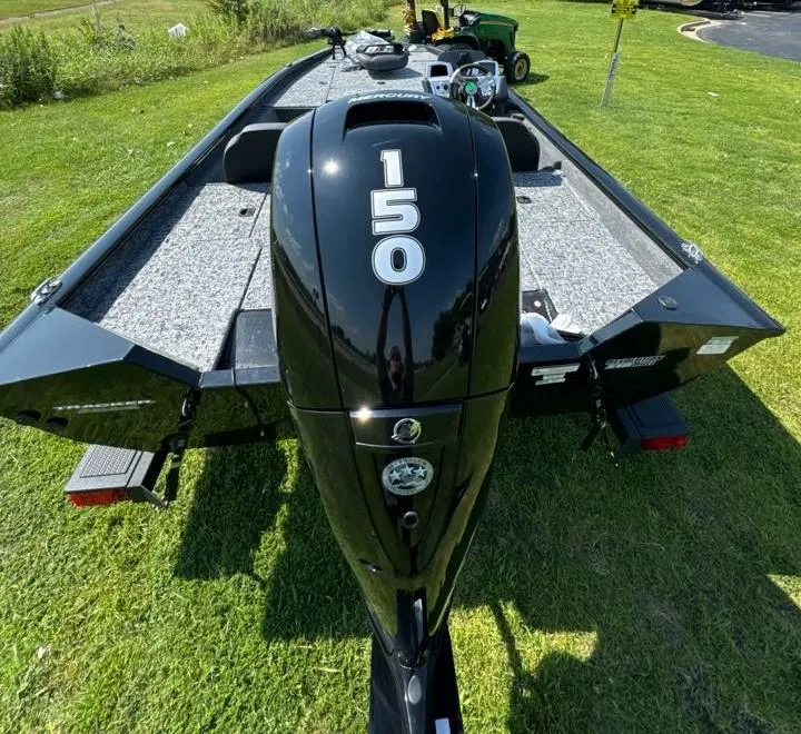 Slide: The Image of 2025 Tracker Pro Team 195 Tournament Edition boat with 150 HP engine on grass. - 6