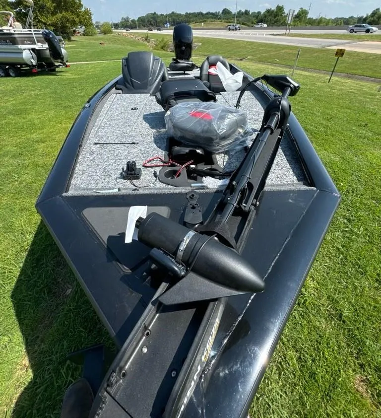 Slide: The Image of 2025 Tracker Pro Team 195 Tournament Edition boat on grass, showcasing deck and equipment. - 7