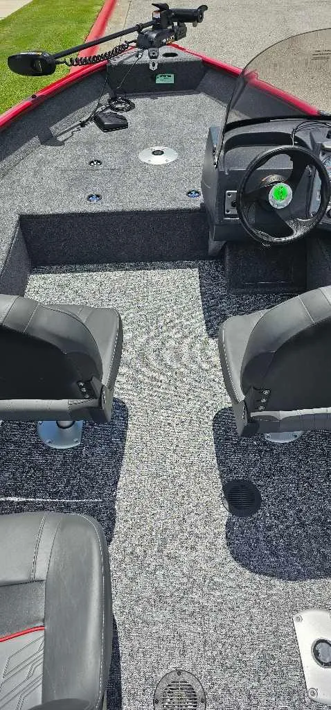 Slide: The Image of 2025 Tracker Pro Guide V-16 SC boat interior with steering wheel and seating. - 3