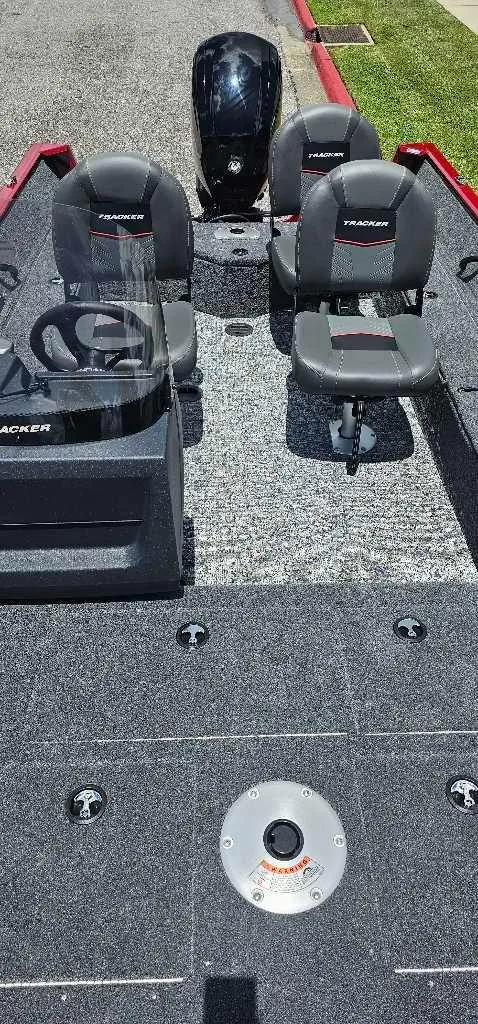 Slide: The Image of 2025 Tracker Pro Guide V-16 SC boat interior with seating and motor. - 4