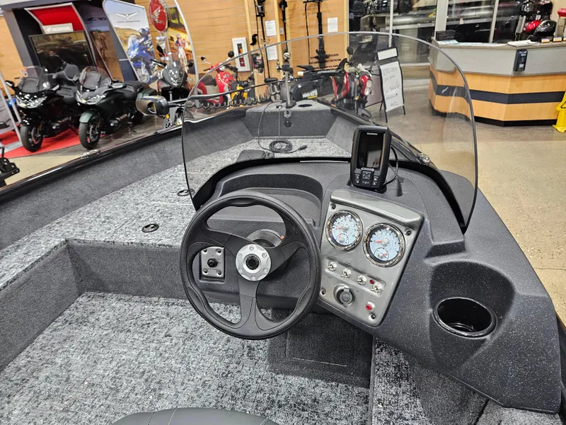 Slide: The Image of 2025 Tracker Pro Guide V-16 SC boat interior with steering wheel and dashboard controls. - 13