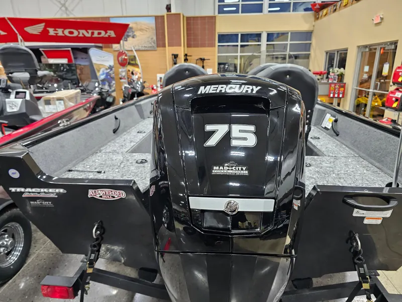 Slide: The Image of 2025 Tracker Pro Guide V-16 SC boat with Mercury 75 engine in showroom. - 4