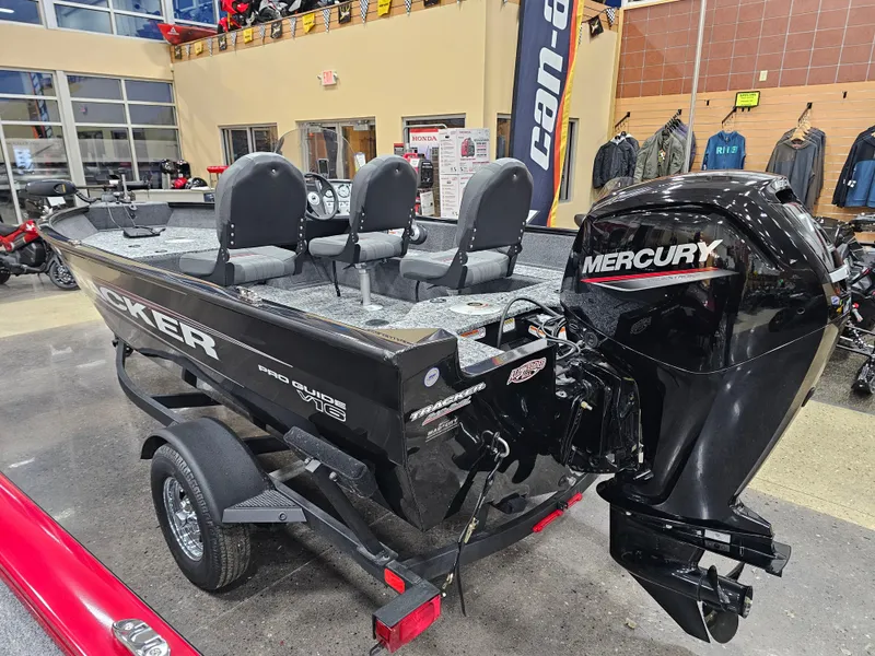 Slide: The Image of 2025 Tracker Pro Guide V-16 SC boat with Mercury engine in showroom. - 5