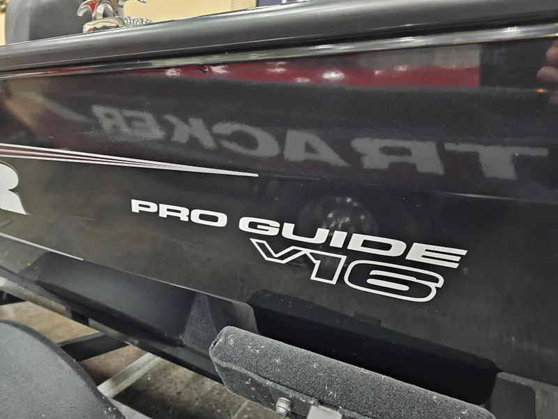 Slide: The Image of 2025 Tracker Pro Guide V-16 SC boat, close-up of model name on hull. - 6