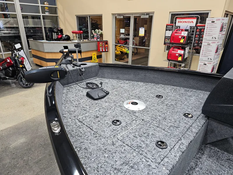 Slide: The Image of 2025 Tracker Pro Guide V-16 SC boat interior with fishing deck in showroom. - 7