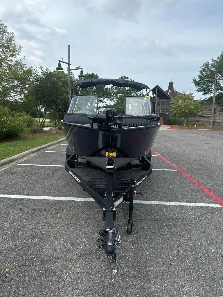 Slide: The Image of 2025 Tracker Pro Guide V-175 Combo boat on trailer in parking lot. - 2
