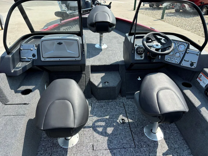 Slide: The Image of 2025 Tracker Pro Guide V-175 Combo boat interior with seating and dashboard controls. - 4
