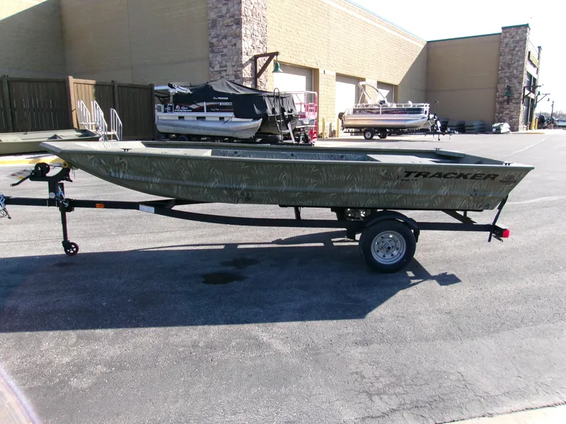 Slide: The Image of 2025 Tracker Grizzly 1648 Jon boat on trailer in outdoor showroom. - 2