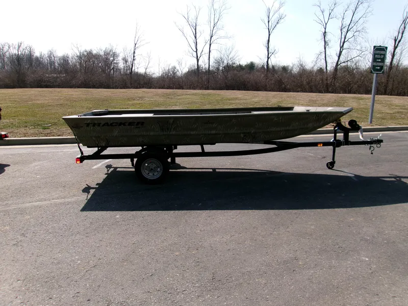 Slide: The Image of 2025 Tracker Grizzly 1648 Jon boat on trailer in parking lot. - 3