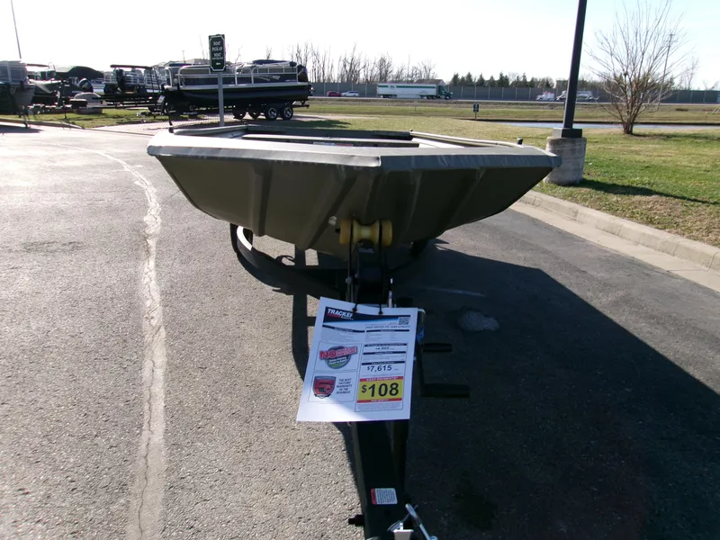 Slide: The Image of 2025 Tracker Grizzly 1648 Jon boat on trailer in outdoor dealership lot. - 5