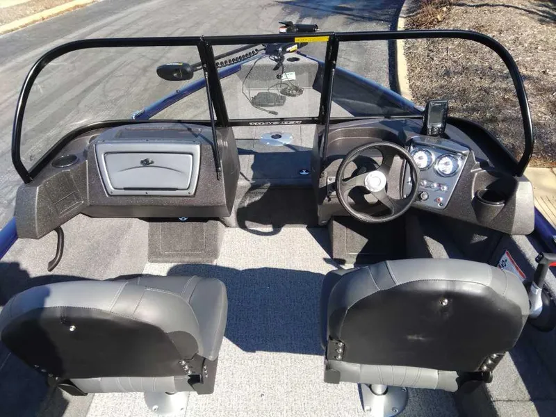 Slide: The Image of 2025 Tracker Pro Guide V-175 Combo boat interior with dual seats and steering console. - 3