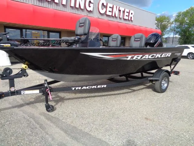 Slide: The Image of 2025 Tracker Pro Guide V-16 SC boat displayed outside a boating center. - 2