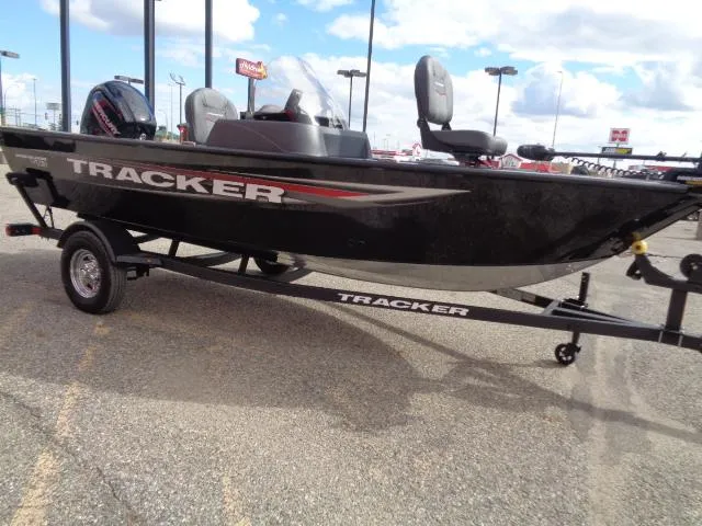 Slide: The Image of 2025 Tracker Pro Guide V-16 SC boat on trailer, parked outdoors. - 4