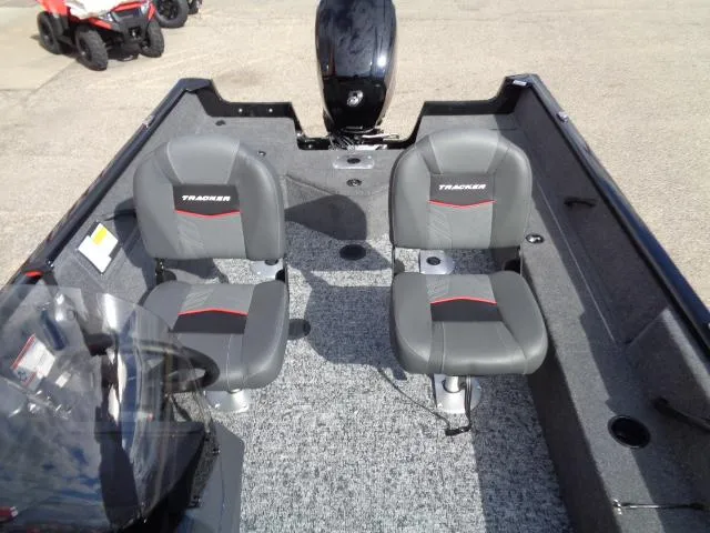 Slide: The Image of 2025 Tracker Pro Guide V-16 SC boat interior with two gray seats and motor. - 6