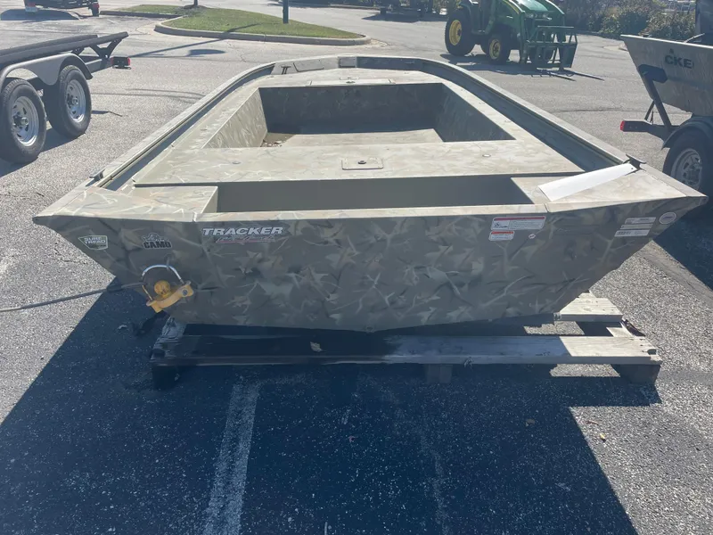 Slide: The Image of 2025 Tracker Grizzly 1754 Jon boat on trailer in parking lot. - 2
