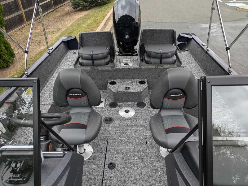Slide: The Image of 2025 Tracker Pro Guide V-175 Combo boat interior with seating and motor. - 2