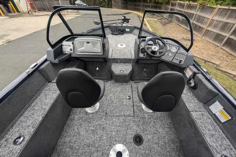 Slide: The Image of 2025 Tracker Pro Guide V-175 Combo boat interior with dual seats and steering console. - 4