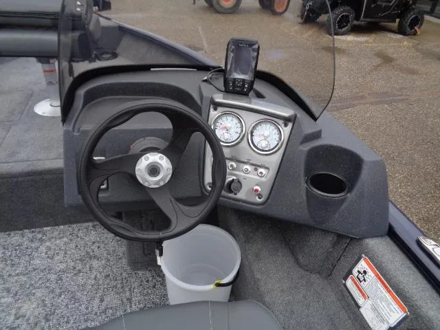 Slide: The Image of 2025 Tracker Pro Guide V-16 SC boat dashboard with steering wheel and gauges. - 10