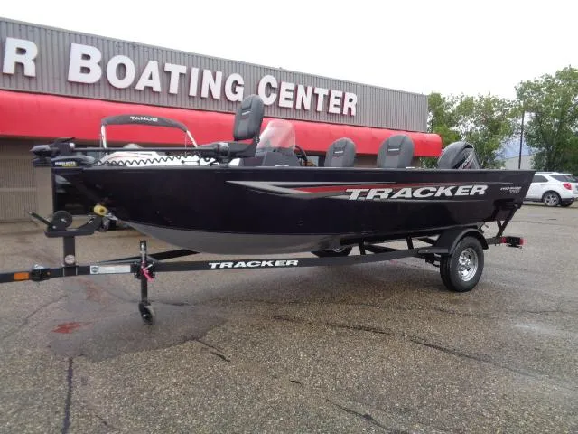 Slide: The Image of 2025 Tracker Pro Guide V-16 SC boat at dealership, parked on trailer. - 2