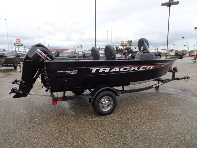 Slide: The Image of 2025 Tracker Pro Guide V-16 SC boat on trailer in parking lot. - 3